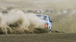 Rally car kicking up dust